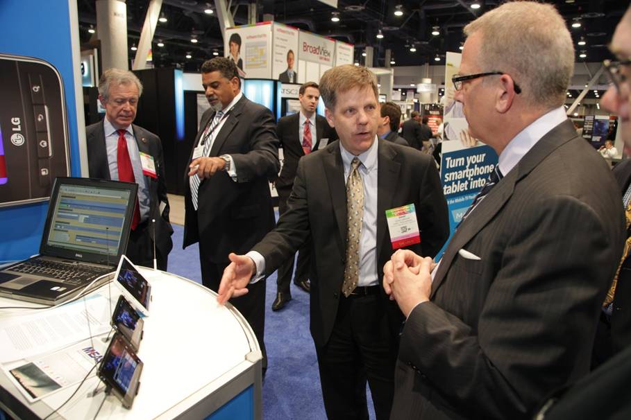 FCC’s Public Safety and Homeland Security Bureau Chief, Rear Adm. David Simpson, USN (ret.), discusses M-EAS with John Lawson (right) at NAB 2014.