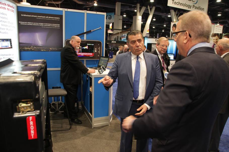 Univision Chairman Haim Saban discusses M-EAS station equipment with John Lawson at NAB 2014.